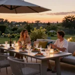 Enjoying modern patio furniture during sunset with dining set and sofa.