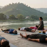 Best yoga teacher training in Rishikesh India with serene sunrise yoga practice by the Ganges, promoting tranquility and mindfulness.